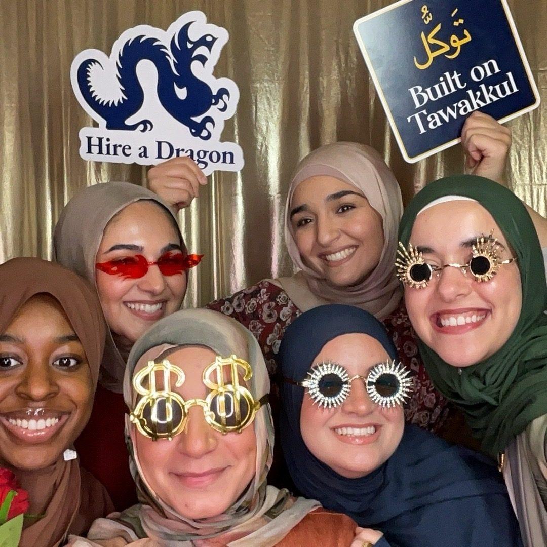 Group with fun glasses and custom prop signs at a Philadelphia university banquet photo booth