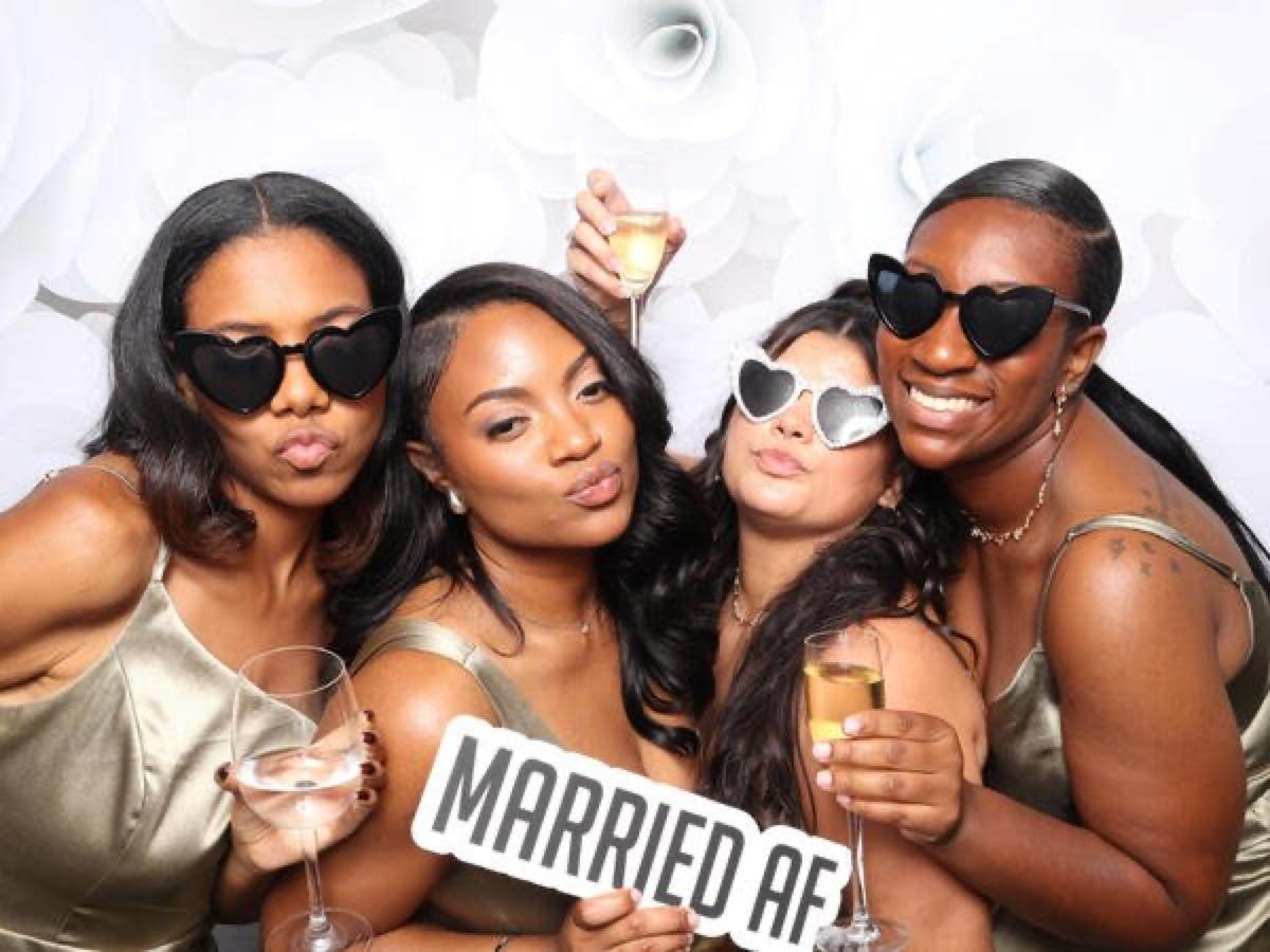 Wedding guests celebrating with champagne in a Philadelphia photo booth